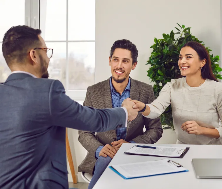 Couple Shaking Hands With A Banker