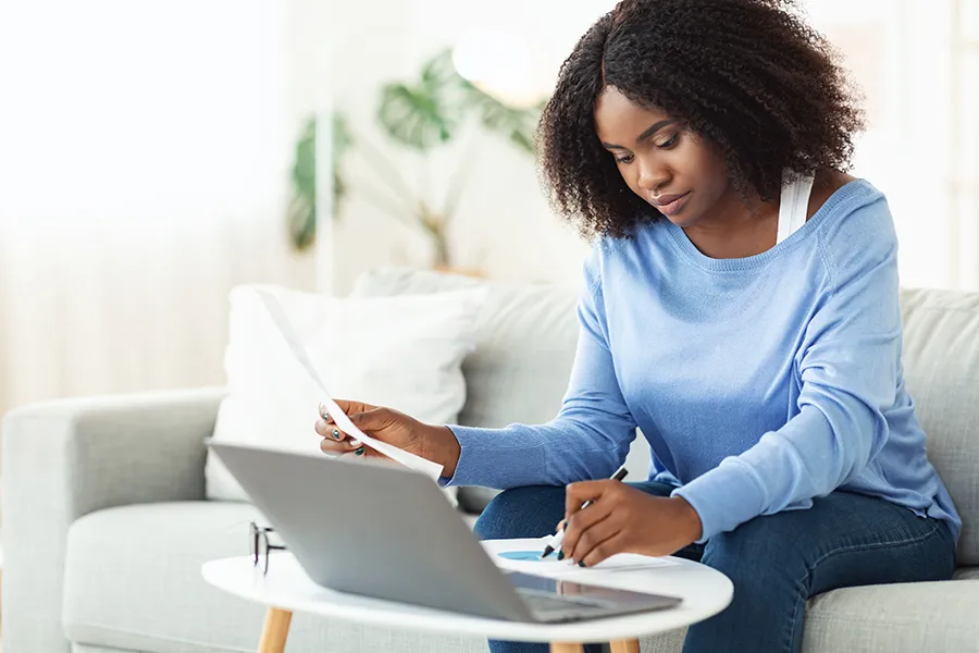 Young Woman Creating A Budget And Preparing For A Recession 900X600